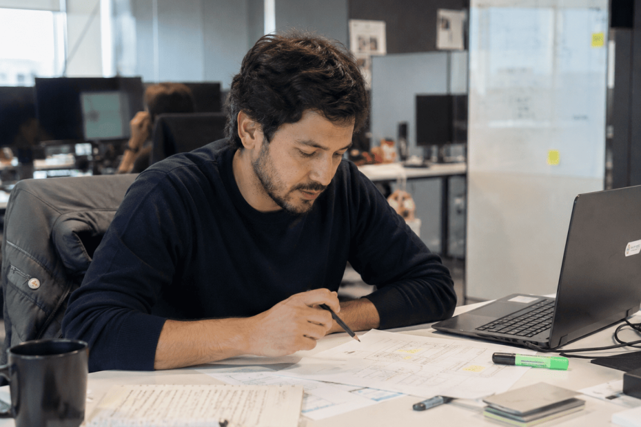 Profesional chileno analizando el feedback de su jefatura para reestructurar un proyecto de mejora operativa.